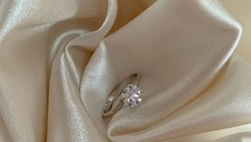 diamond engagement ring on white cloth (1)