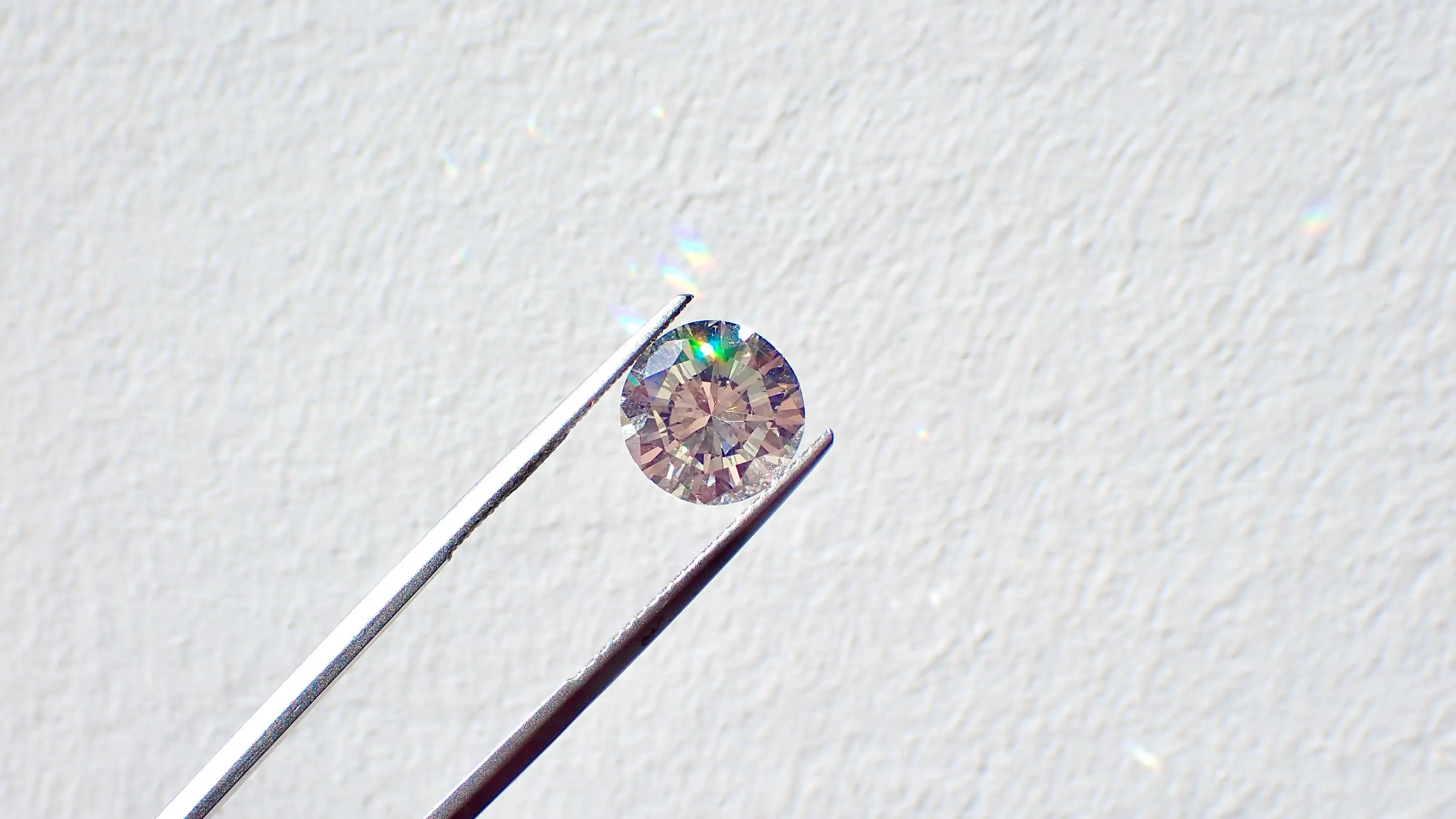 holding up lab grown diamonds