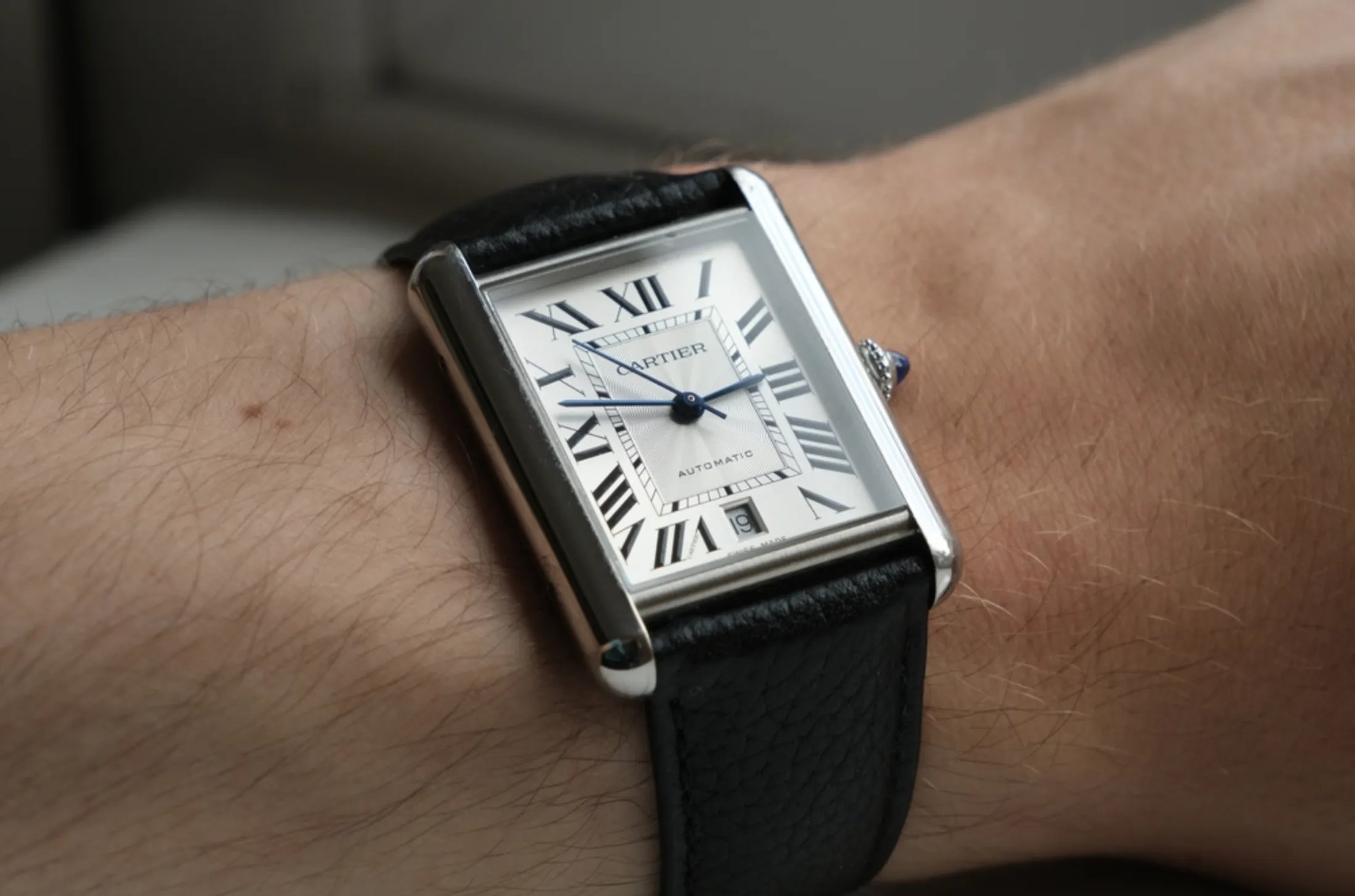 A Cartier Tank owner wearing his luxury watch.