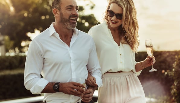  A happy couple on holiday wearing their luxury watches.  