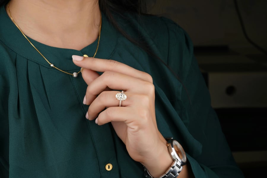 woman holding her necklace