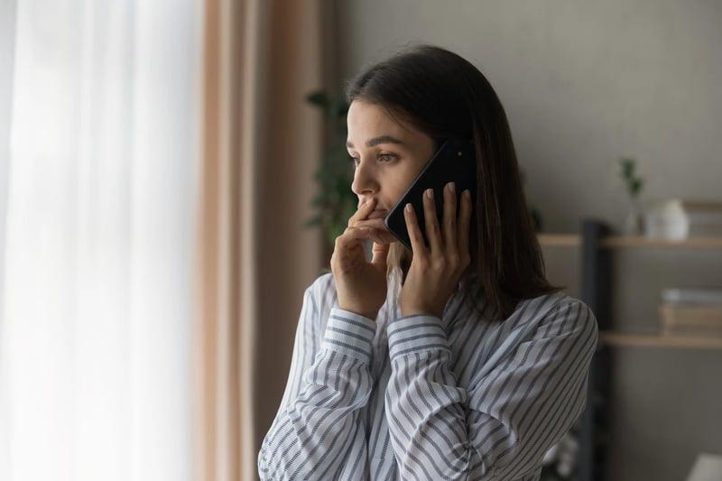 woman on phone to engagement ring insurance